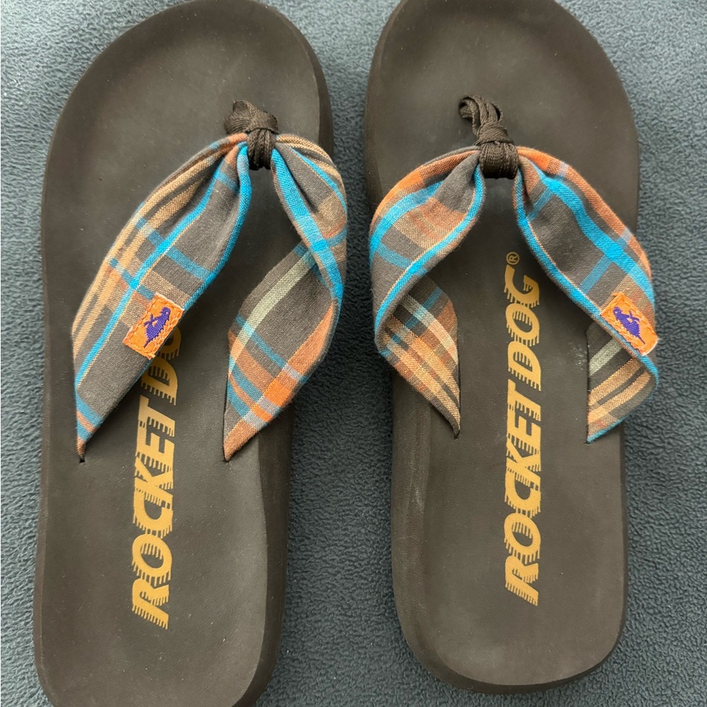 Women’s Rocket Dog flip flops.  Brown and orange plaid. Size: 7.
